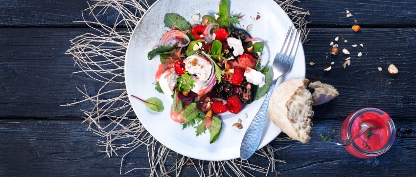 Prunes and goat cheese are classic pairings any time of the year. Make this salad in the winter by substituting roasted, diced beets in place of the raspberries.