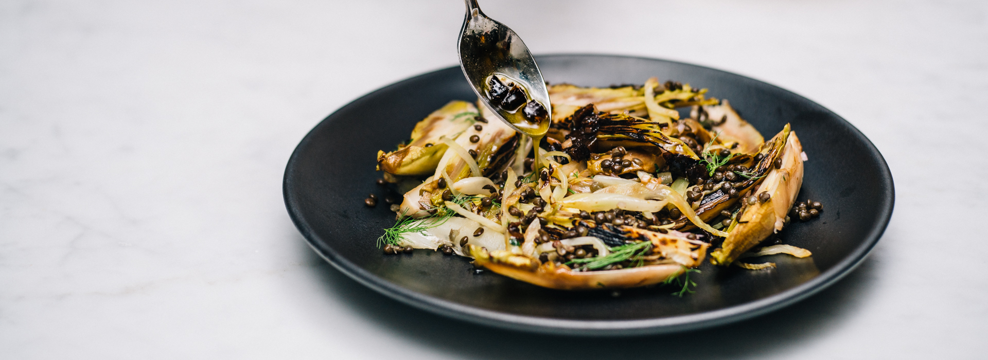 When it's charred, endive and fennel take on a deeper, sweeter flavor in this salad. Here, they're mixed lentils and diced prunes and seasoned with a shallot vinaigrette. 